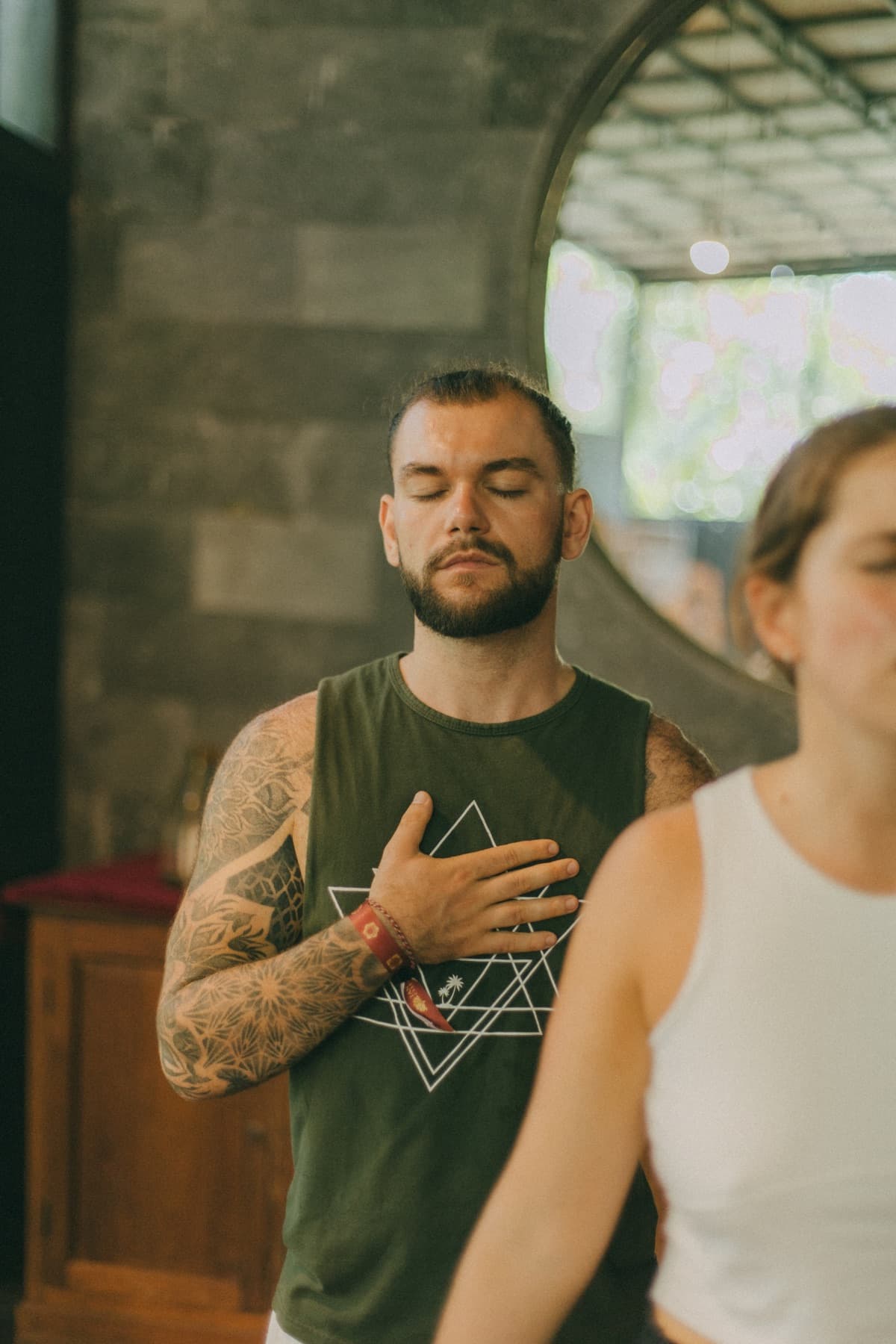Joshua Sting with his eyes closed and a hand resting on his chest
